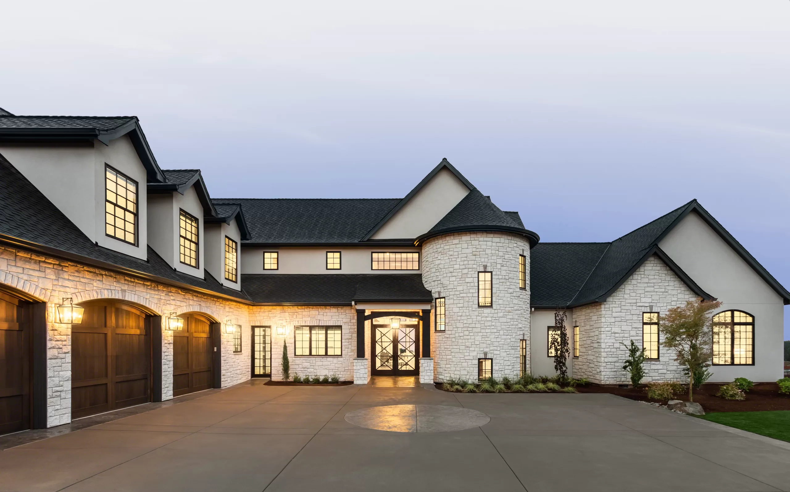 Large white stone home with new shingle roof