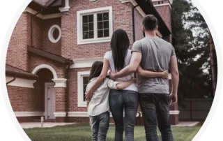 family looking at a brick house