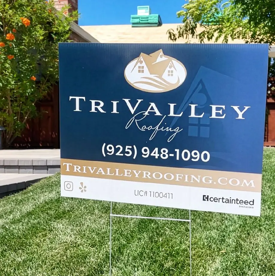 A TriValley Roofing yard sign featuring the CertainTeed logo highlights their Residential Roofing services with the company name, website, phone number, and license number displayed on a lawn in front of a house.