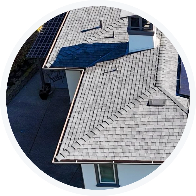 Residential roofing project with gray shingles and gutter system installed by Tri Valley Roofing.