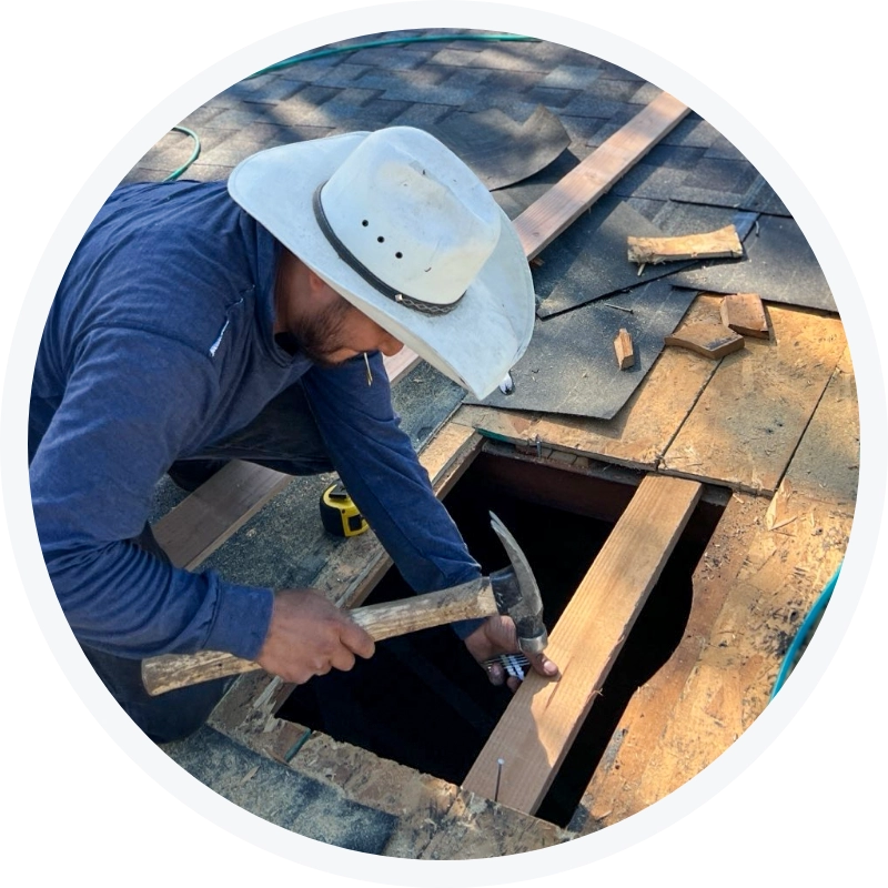 Tri Valley Roofing crew member repairing a roof opening on an asphalt shingle roof.